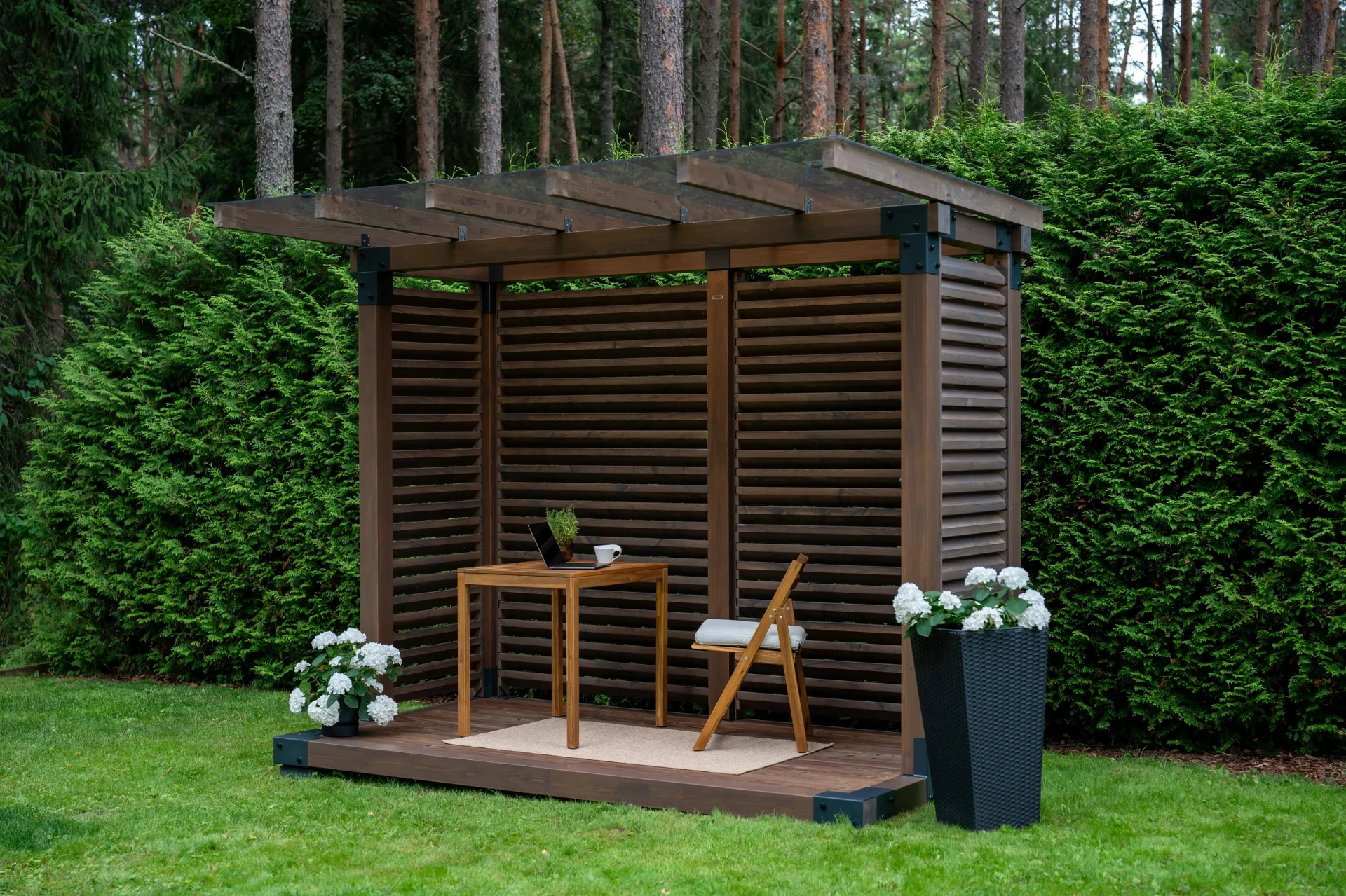 Fjordly Compact set up as an outdoor workspace with a table, laptop and folding chair.
