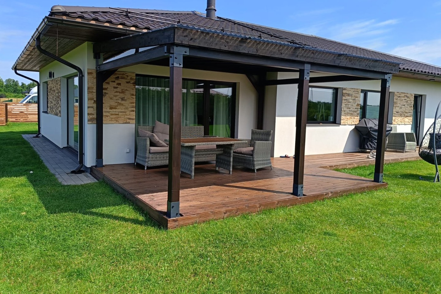 Dark timber terrace roof built onto an existing white family home.