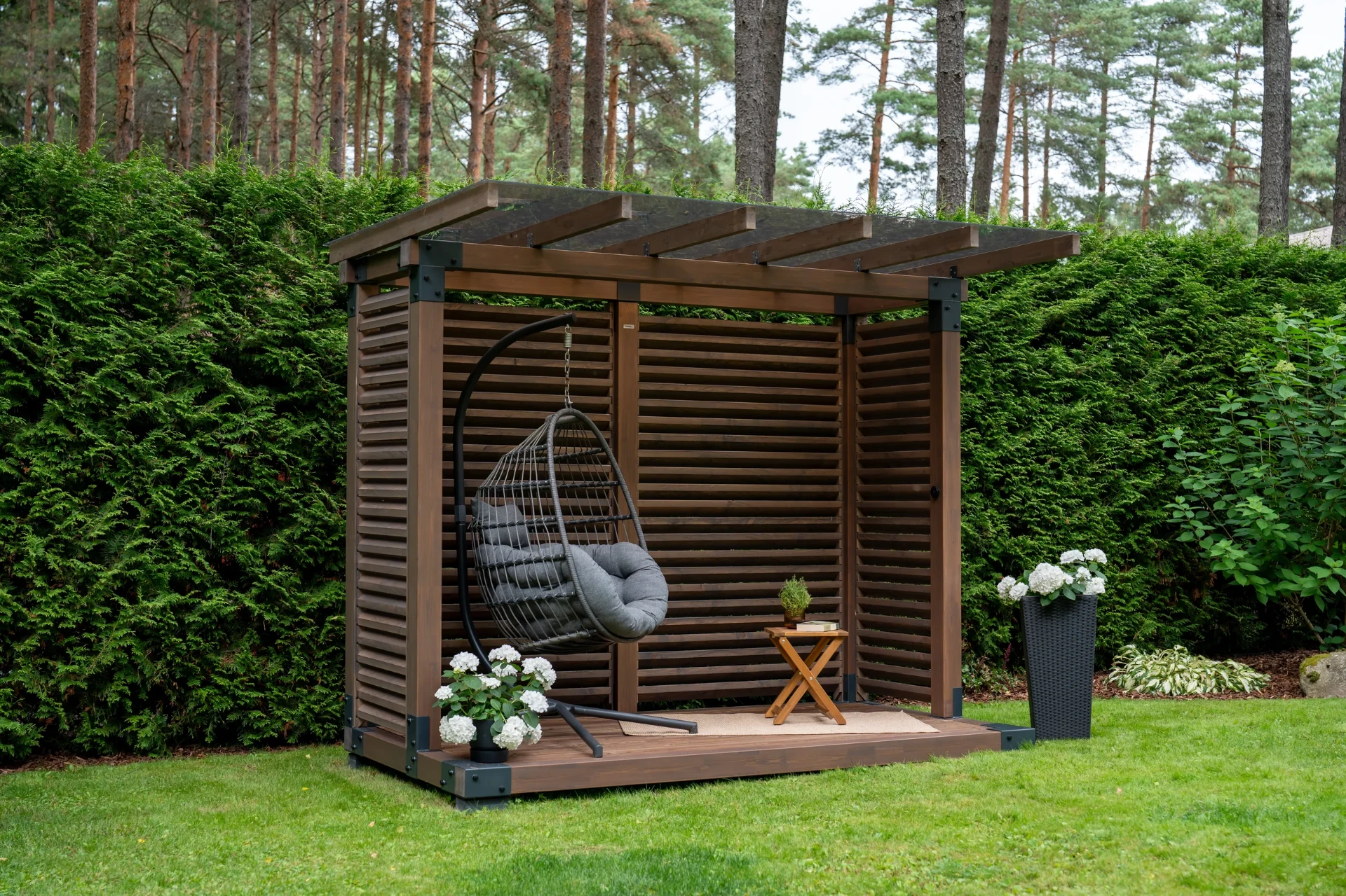 Compact outdoor shelter in a Nordic garden.