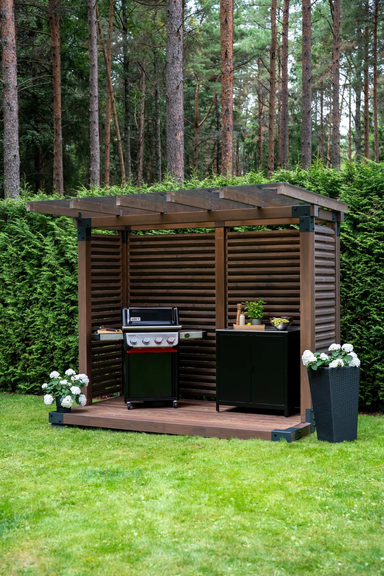 Fjordly Compact set up as an outdoor kitchen with a grill and storage cabinet.